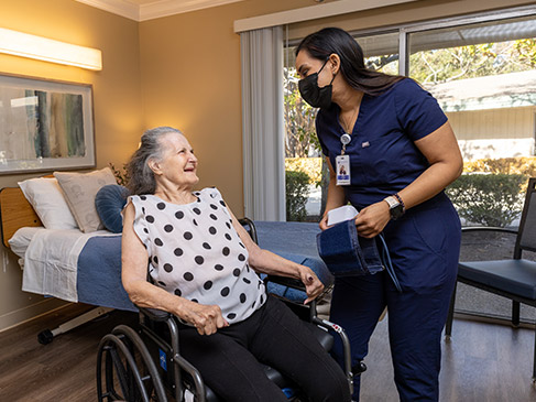 Daughter showing concern for her aging mother who's in a wheelchair